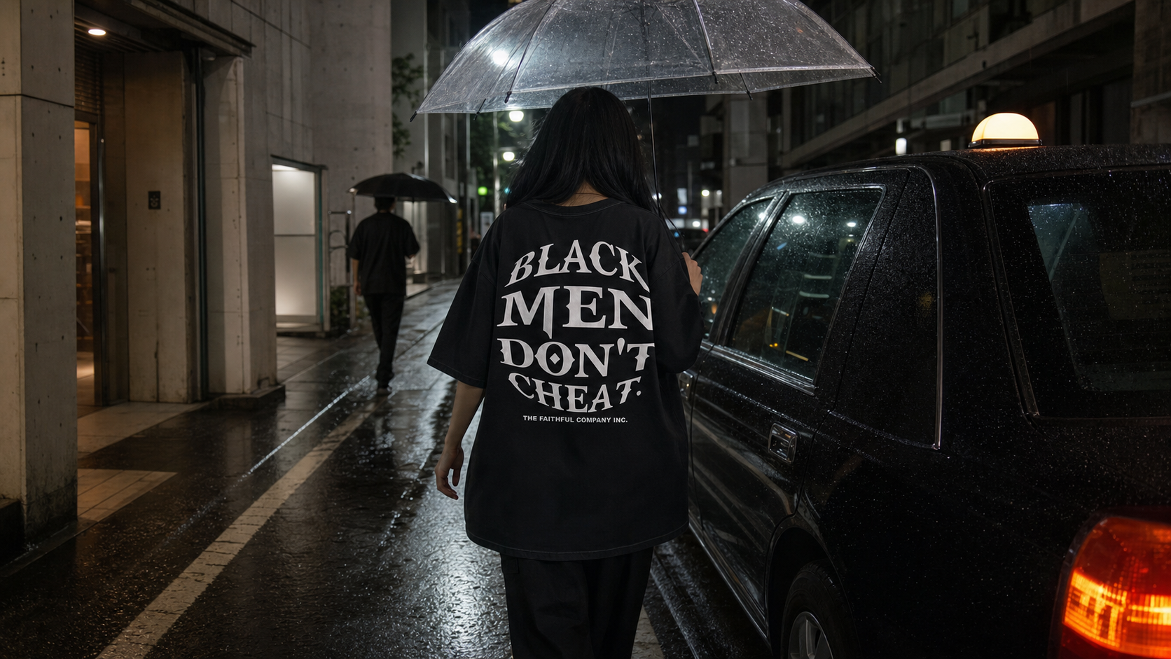 Back view of the Debut Tee on a rainy Tokyo street